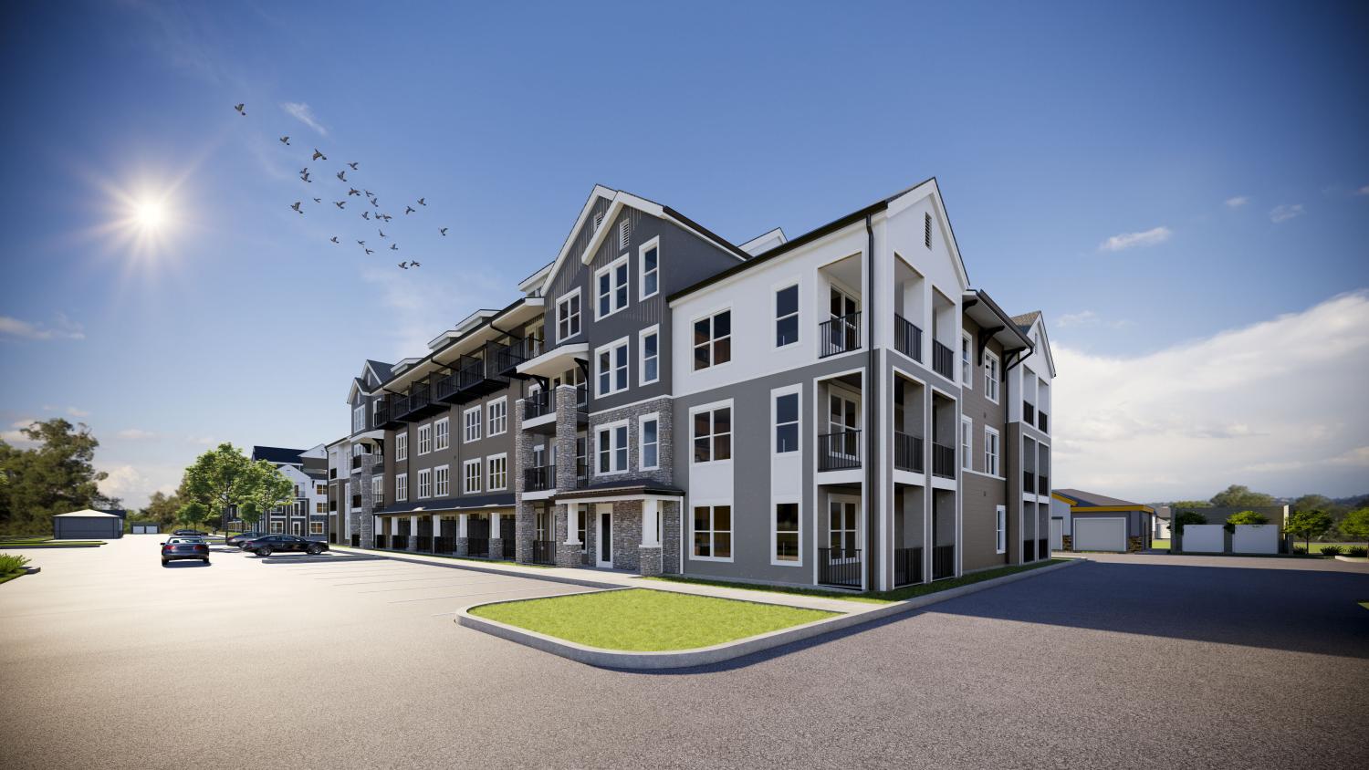Modern three-story apartment building under bright sun at The Pointe at Overlook, featuring private balconies and stone accents