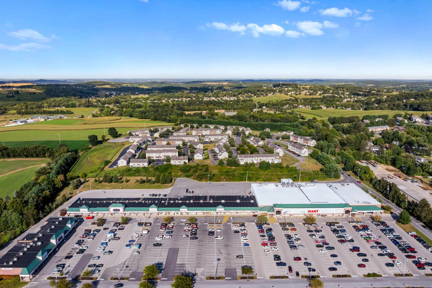Nearby shopping center next to Windsor Commons Townhomes with grocery, retail, and ample parking for resident convenience.