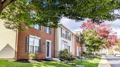 Mill Creek Manor townhomes with tree-lined sidewalks and colorful autumn foliage