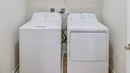 Convenient in-unit full-size washer and dryer appliances provided in a dedicated alcove at Riverview Terrace apartments, offering effortless laundry at home.