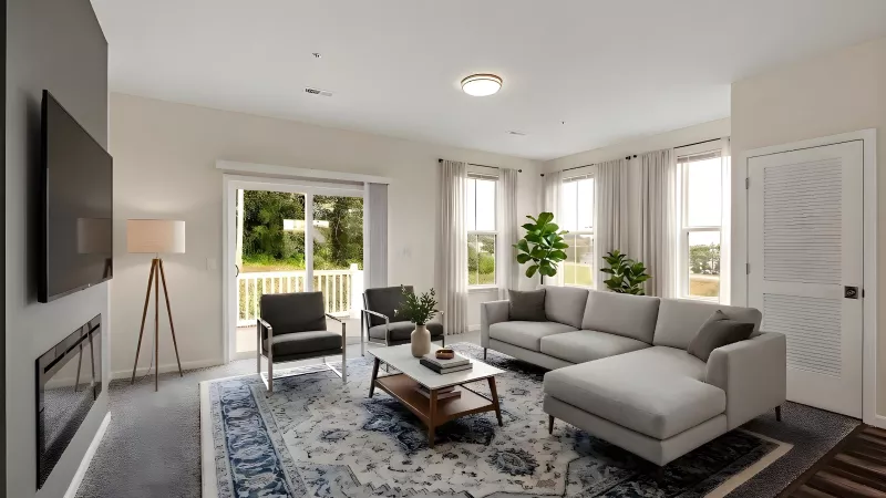 Modern living room with a gray sectional, TV, fireplace, blue rug, and sliding door to a balcony.