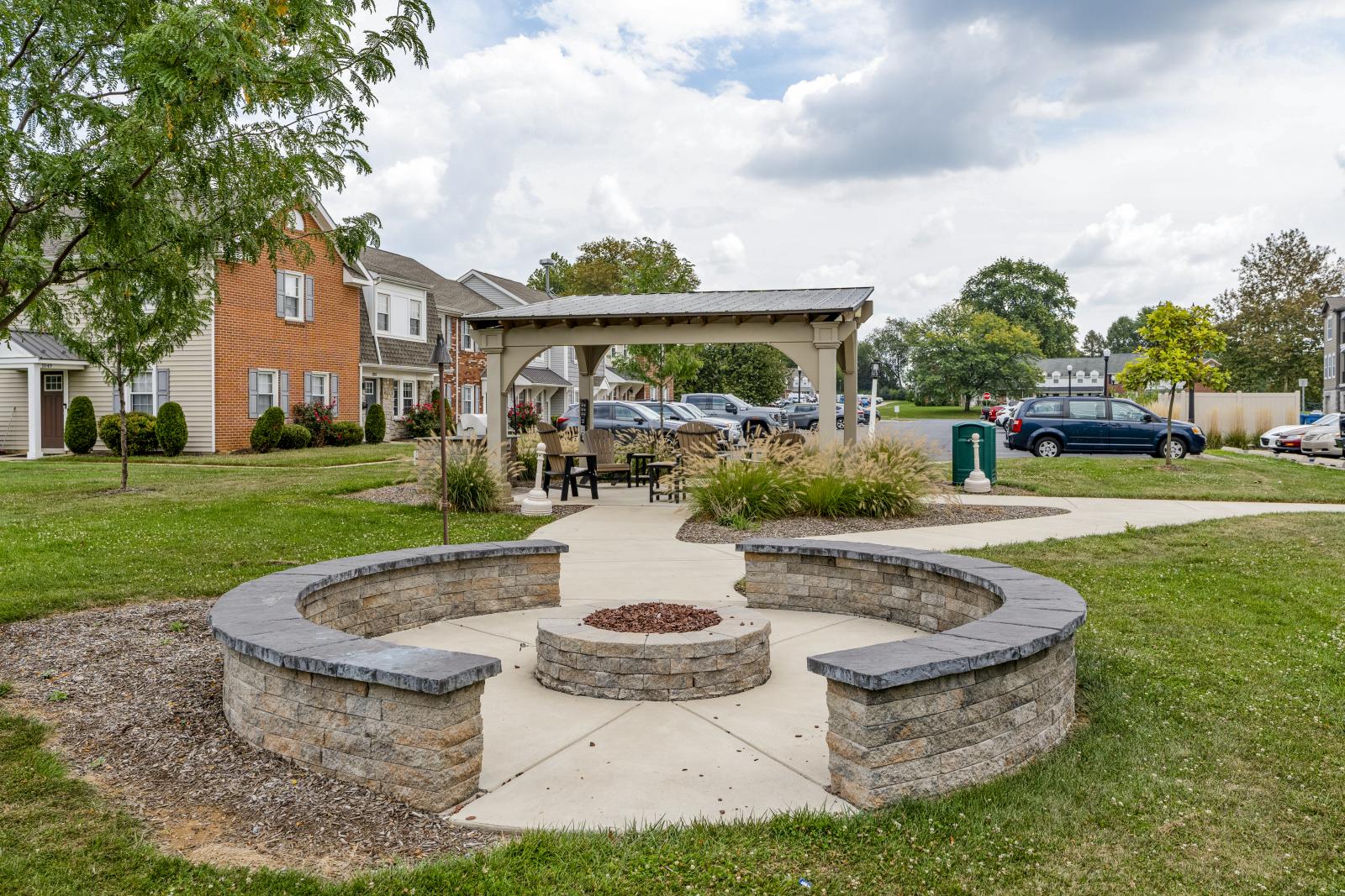 Outdoor community firepit surrounded by seating, ideal for social gatherings and relaxation.