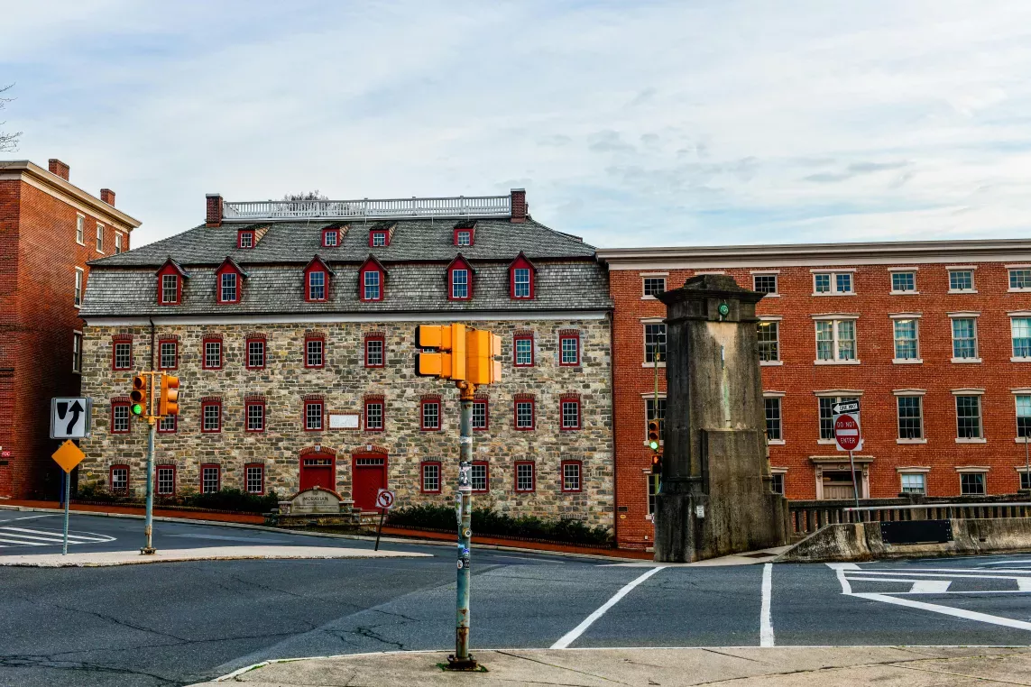 Historic brick and stone buildings with red-trimmed windows at a city intersection Near Bethlehem Pennsylvania, featuring crosswalks, traffic lights, and a “Do Not Enter” sign.