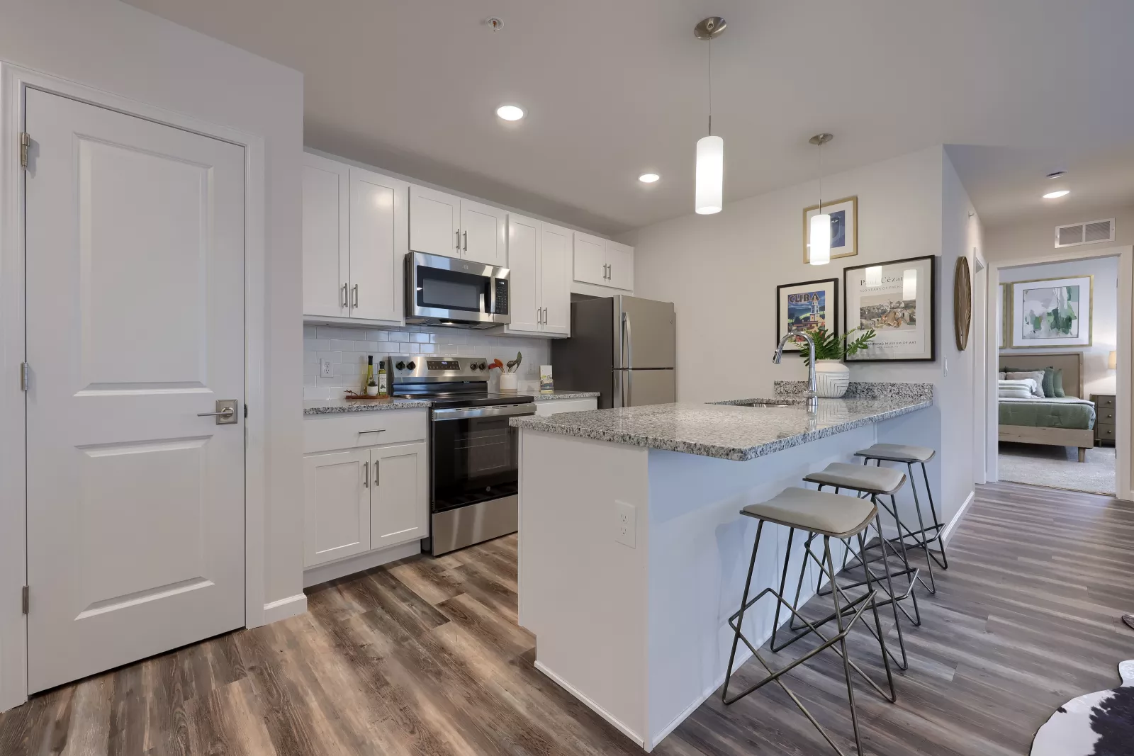 Spacious kitchen with stainless steel appliances, wood cabinetry, and a center island.