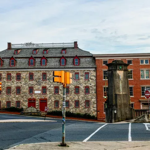 Historic brick and stone buildings with red-trimmed windows at a city intersection Near Bethlehem Pennsylvania, featuring crosswalks, traffic lights, and a “Do Not Enter” sign.