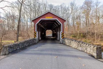 A quiet country road leads to Kurtz Mill Covered Bridge in Lancaster County, Pennsylvania.