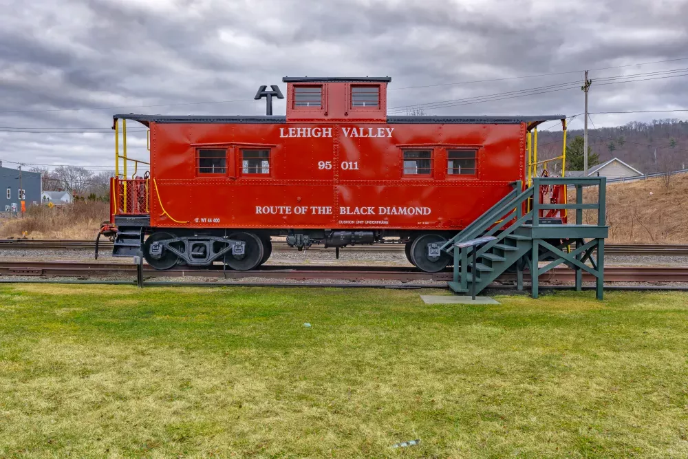 Restored red vintage caboose at the Sayre Historical Society Museum at Lehigh Valley Railroad Passenger Station