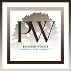 Pioneer Woods apartment community logo featuring the PW initials and a large tree silhouette.