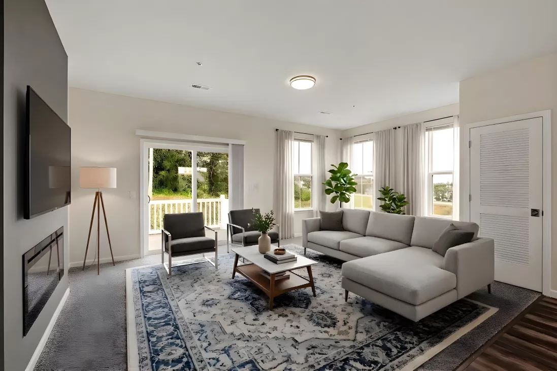 Modern living room with a gray sectional, TV, fireplace, blue rug, and sliding door to a balcony.