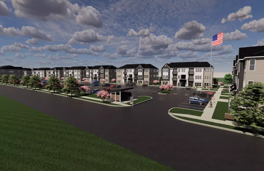 Graphic rendering of a new apartment complex with multi-story buildings, parking, landscaping with pink trees, and a US flag.